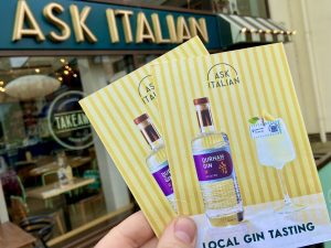 flyers promoting local gin-tasting event outside ask Italian in Durham